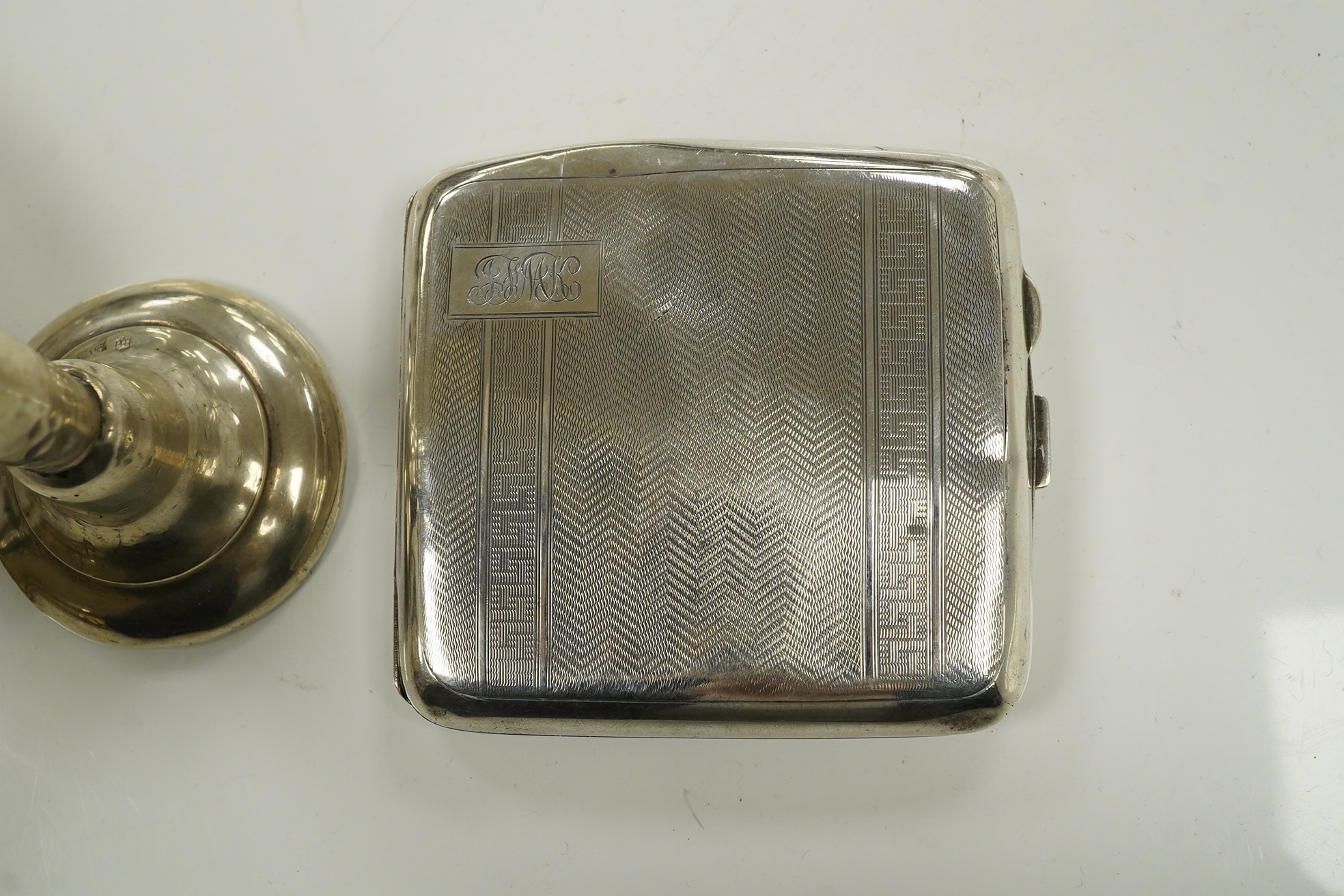 A George VI silver sauceboat, a George III drum mustard, a George V cigarette case and a loaded specimen vase, 10.5 oz of weighable silver. Condition - mustard lacks liner, vase dented, otherwise good